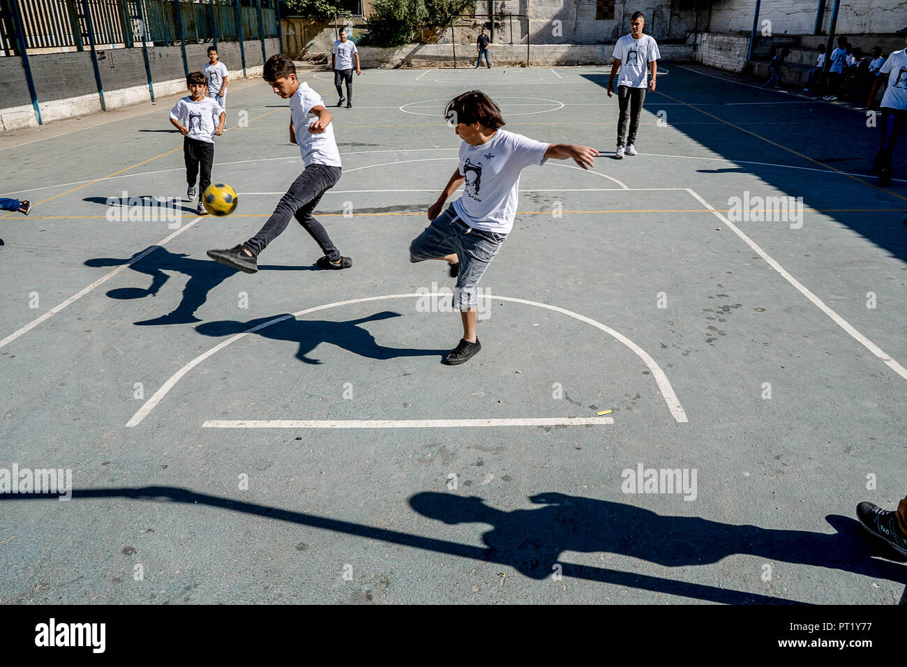 Bethlehem, Palestine. 13th Feb, 2018. Students are seen playing football in the courtyard during the summer camp.The Return Summer Camp was organised for children of the Aida refugee camp, it was established in 1950 by the Palestinians who were expelled from their homes from 27 towns throughout Palestine, namely Nasra, Tabaria, Jerusalem, Acre, Jaffa, Haifa and Hebron. This is a 4th generation of refugees, 130 children ranging from 4 to 16 years of age being overlooked by 20 instructors and volunteers and it was funded by the UN until 2000. (Credit Image: © Enzo Tomasiello/SOPA Images vi Stock Photo
