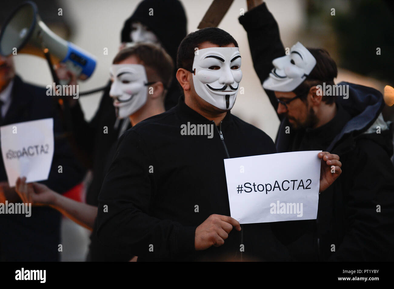 Krakow, Poland. 5th Oct, 2018. Protesters with Guy Fawkes masks seen with posters taking part in the demonstration.Protest against the implemented EU Copyright Directive (known as ACTA 2.0) in front of Adam Mickiewicz Monument at the Main Square.Fa Credit: ZUMA Press, Inc./Alamy Live News Stock Photo