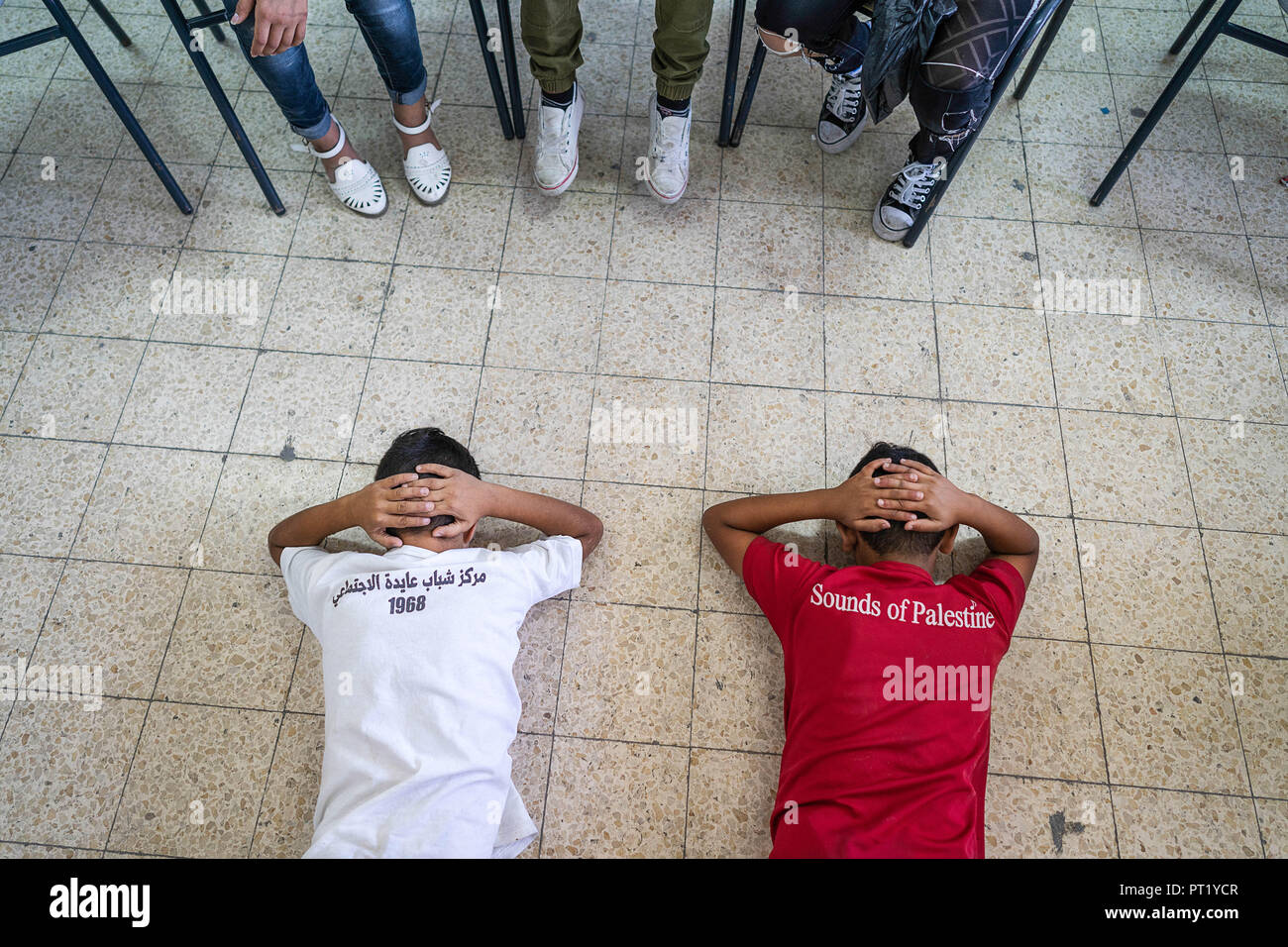 Bethlehem, Palestine. 14th Feb, 2018. Students are seen In a drama class re-acting a situation where Palestinian youths were arrested by the Israeli forces during the summer camp.The Return Summer Camp was organised for children of the Aida refugee camp, it was established in 1950 by the Palestinians who were expelled from their homes from 27 towns throughout Palestine, namely Nasra, Tabaria, Jerusalem, Acre, Jaffa, Haifa and Hebron. This is a 4th generation of refugees, 130 children ranging from 4 to 16 years of age being overlooked by 20 instructors and volunteers and it was funded by Stock Photo