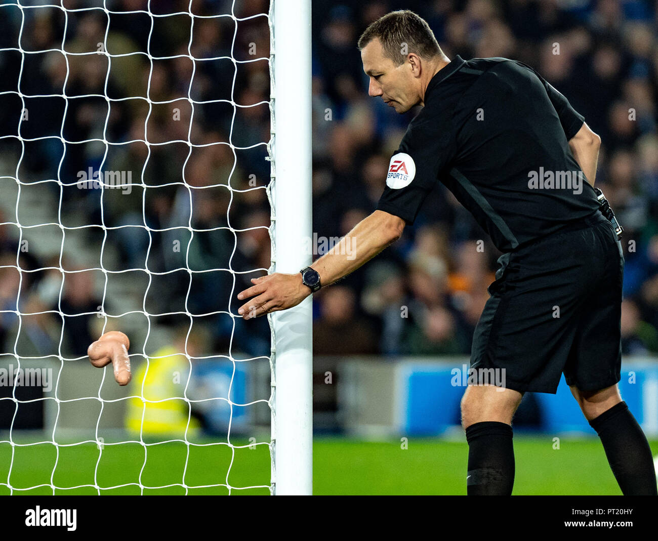 Brighton, UK. 05th Oct, 2018. Referee Kevin Friend removes a adult toy from the pitch during the Premier League match between Brighton and Hove Albion and West Ham United at the AMEX Stadium, Brighton and Hove, England on 5 October 2018. Photo by Liam McAvoy. Credit: UK Sports Pics Ltd/Alamy Live News Stock Photo