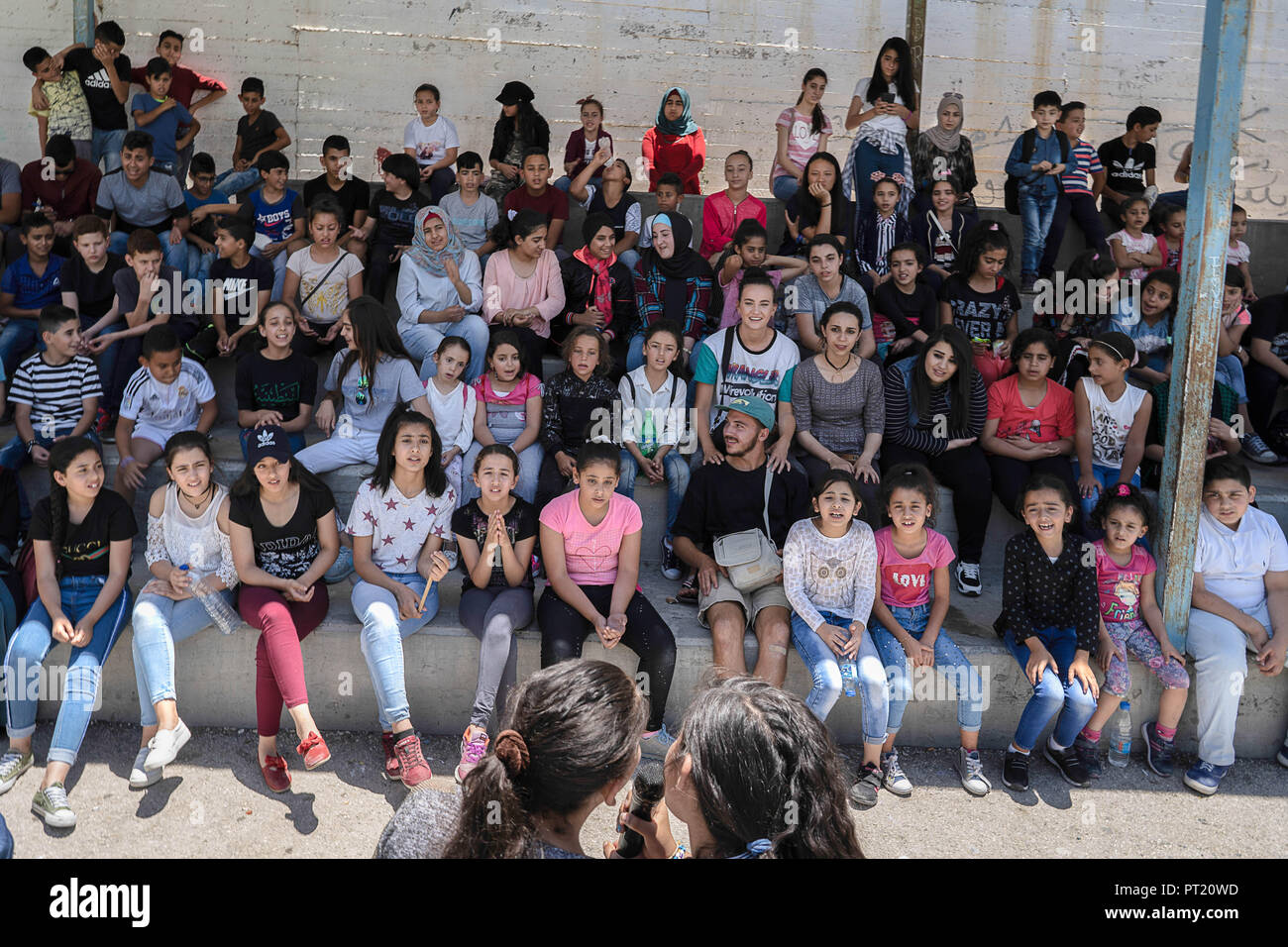Bethlehem, Palestine. 9th Feb, 2018. Students seen sited watching their friends singing in the courtyard during the summer camp.The Return Summer Camp was organised for children of the Aida refugee camp, it was established in 1950 by the Palestinians who were expelled from their homes from 27 towns throughout Palestine, namely Nasra, Tabaria, Jerusalem, Acre, Jaffa, Haifa and Hebron. This is a 4th generation of refugees, 130 children ranging from 4 to 16 years of age being overlooked by 20 instructors and volunteers and it was funded by the UN until 2000. (Credit Image: © Enzo Tomasiello Stock Photo