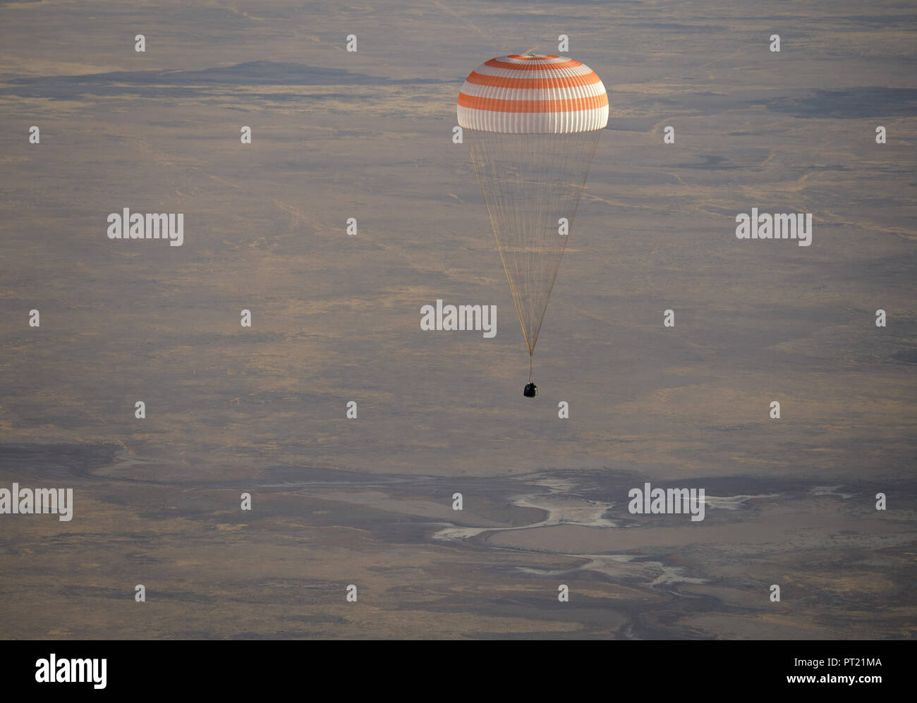 Zhezkazgan, Kazakhstan. 04th Oct, 2018. The Russian Soyuz MS-08 spacecraft drifts down to Earth with the International Space Station Expedition 56 crew October 4, 2018 near Zhezkazgan, Kazakhstan. American astronauts Drew Feustel and Ricky Arnold of NASA, along with Russian Soyuz Commander Oleg Artemyev are returning after 197 days in space. Credit: Planetpix/Alamy Live News Stock Photo