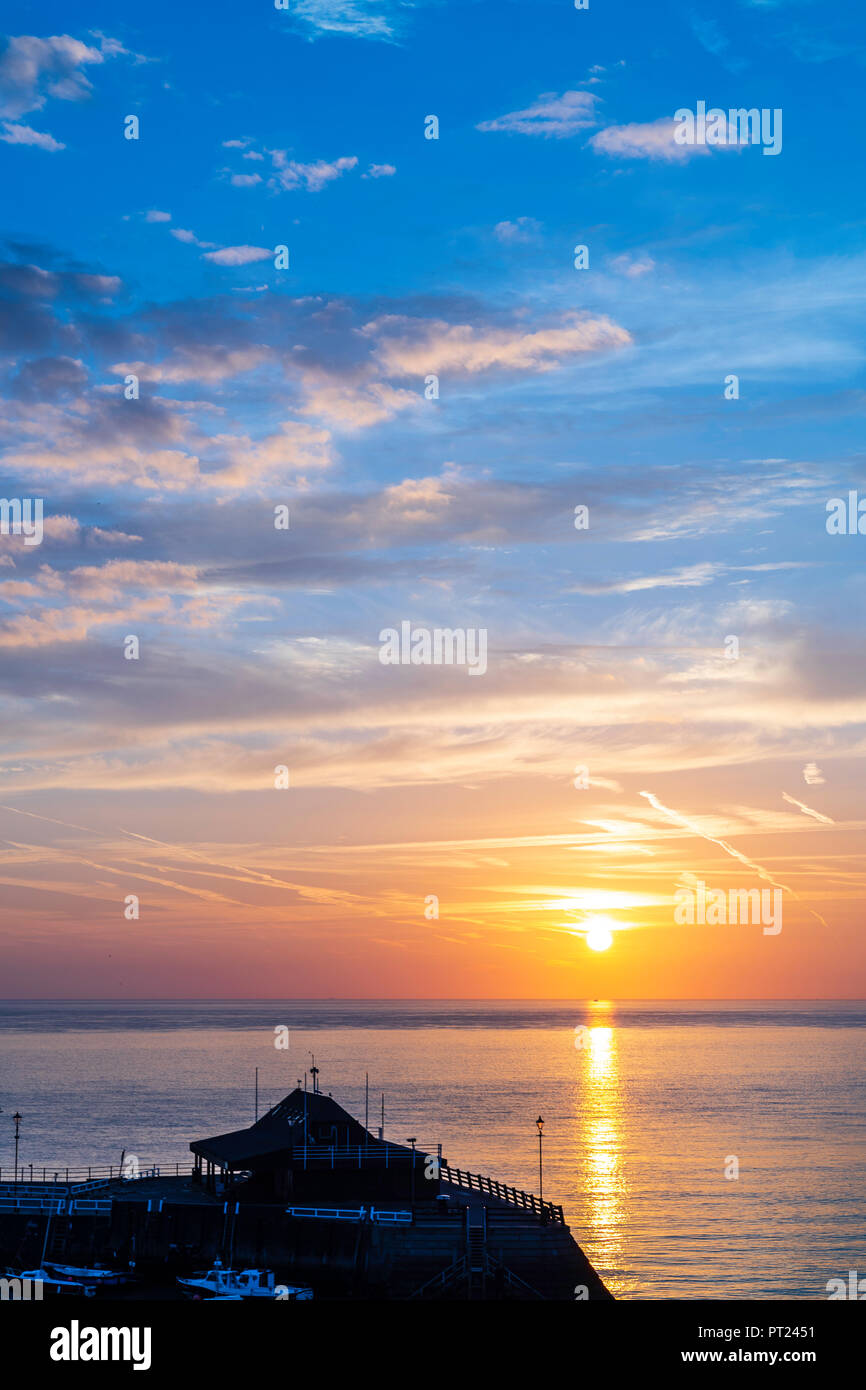 Sunrise Over The Sea And Broadstairs Harbour And Beach At Viking Bay Clouds In The Sky With Orange Band On Horizon And Then Turning To Blue Clouds Reflecting Pink Glow Light From