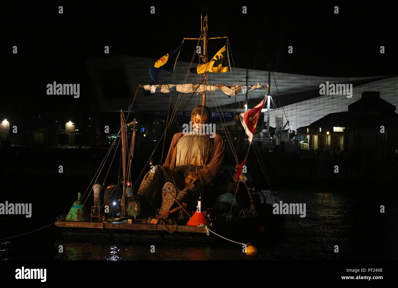 Liverpool, UK. 5 October 2018. Giant puppet resting on a floating raft