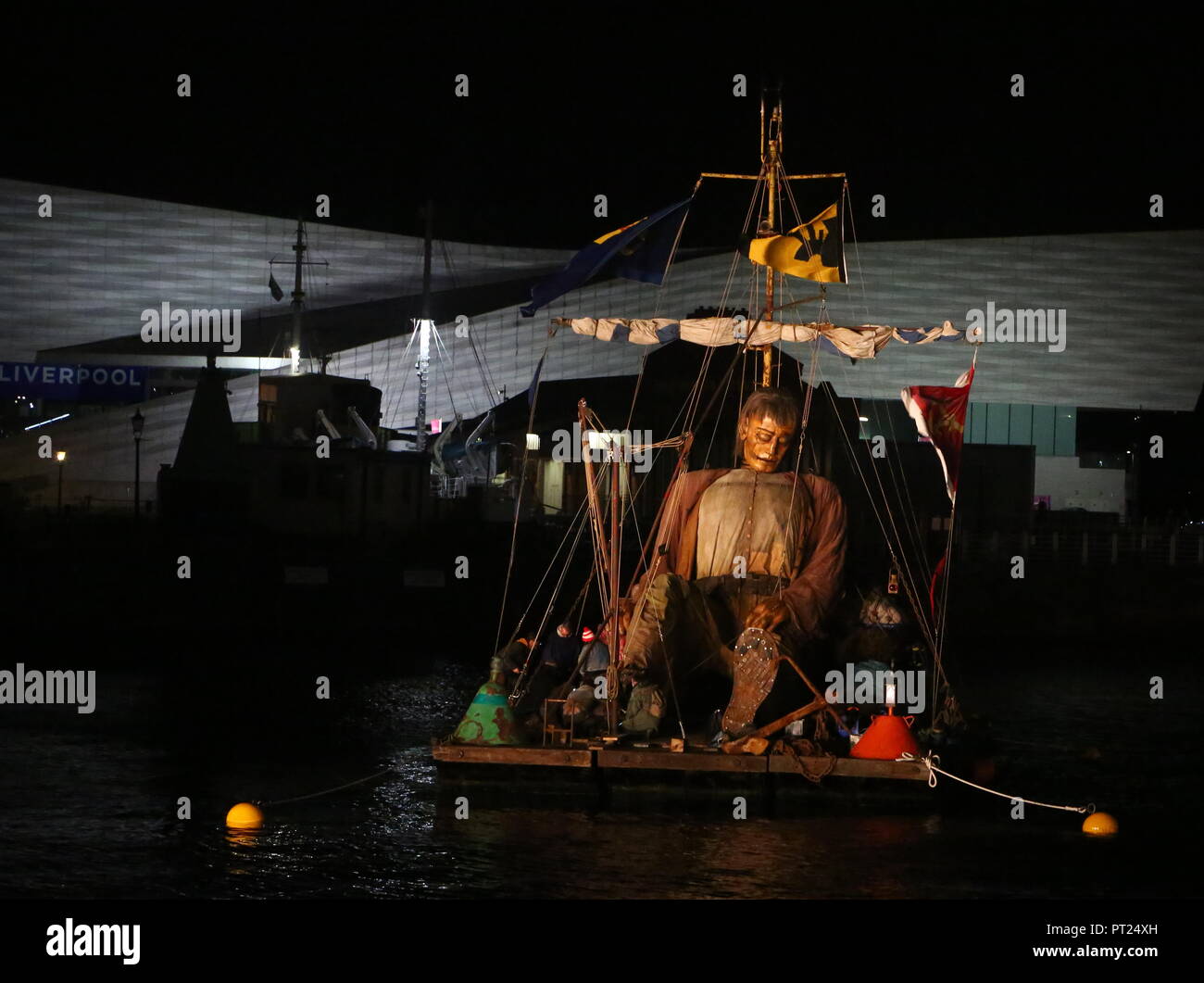 Liverpool, UK. 5 October 2018. Giant puppet resting on a floating raft