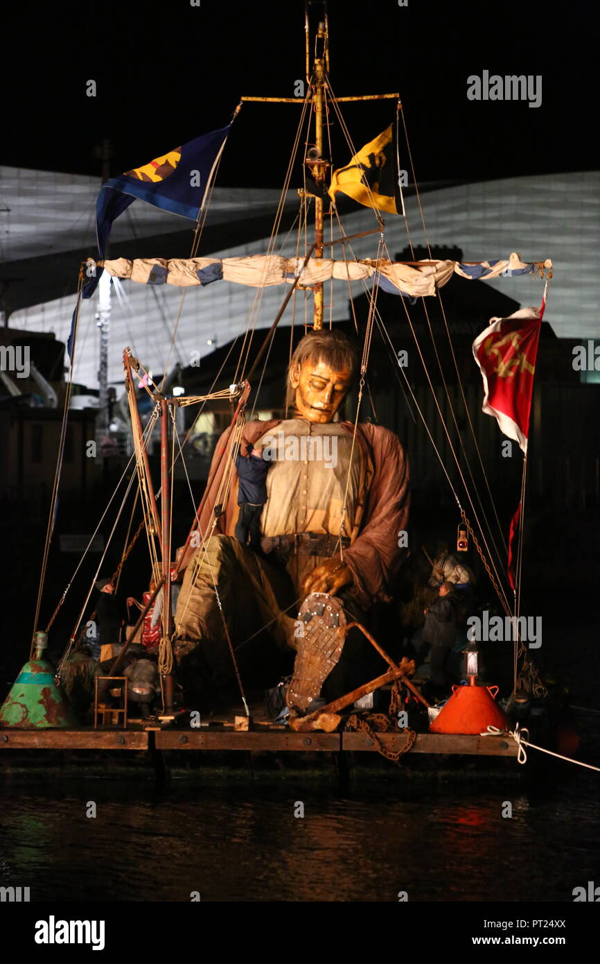 Liverpool, UK. 5 October 2018. Giant puppet resting on a floating raft