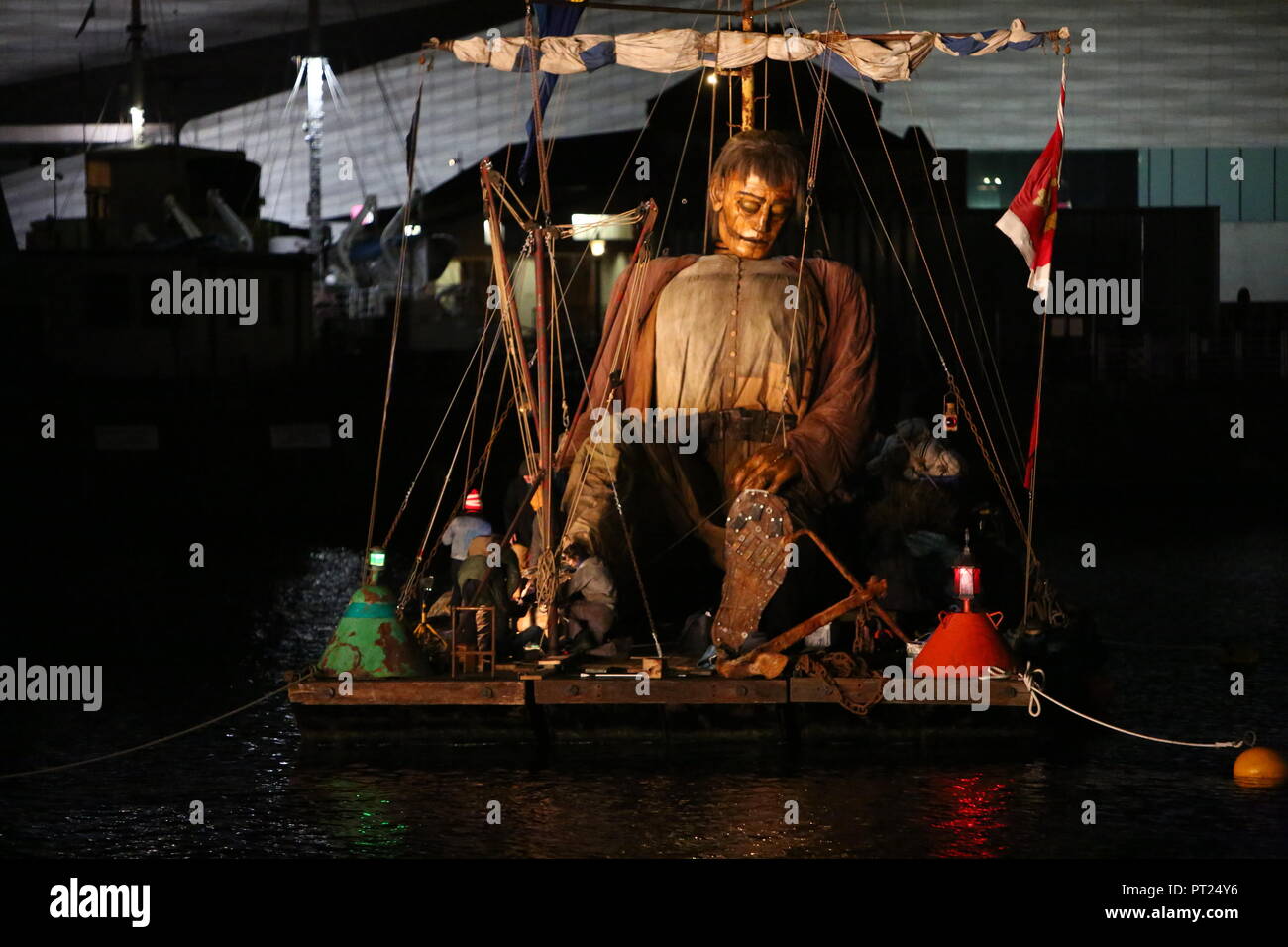 Liverpool, UK. 5 October 2018. Giant puppet resting on a floating raft