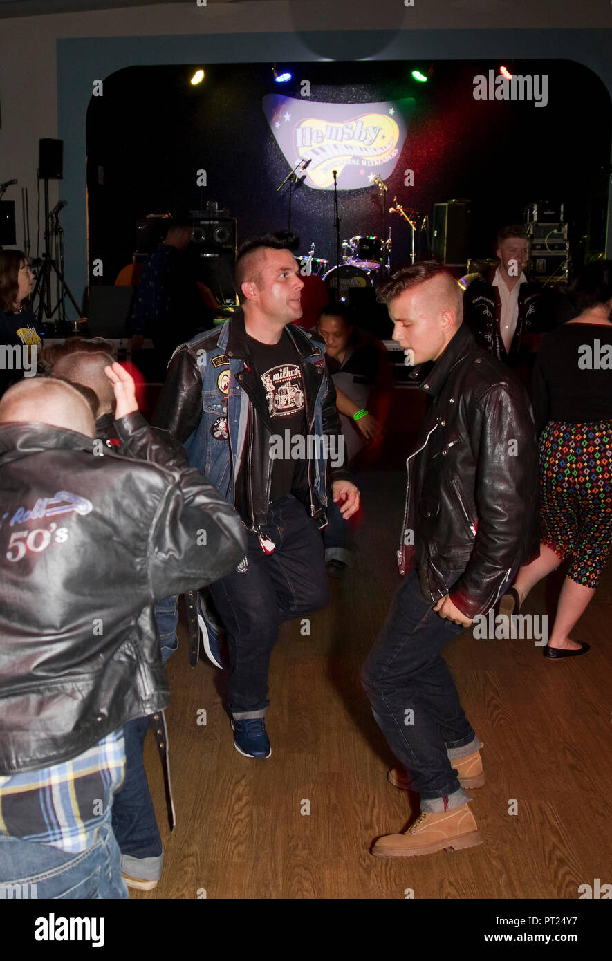 Norfolk, UK. 5 October 2018.  A music phenomena that attracts all ages.  Rockabilly David Monger bopping with his sons, regular visitors to the Hemsby Rock 'n' Roll Weekender.  Credit: Adrian Buck/Alamy Live News Stock Photo