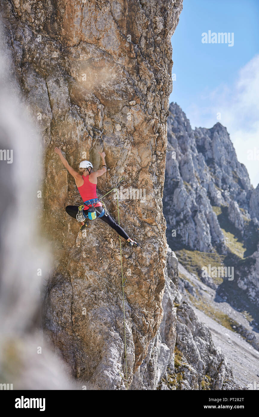 Austria, Innsbruck, Nordkette, woman climbing in rock wall Stock Photo