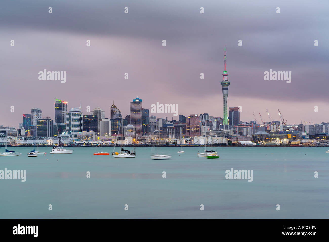 Skyline of Auckland CBD under a gloomy sky at dusk, Auckland City, Auckland region, North Island, New Zealand, Stock Photo