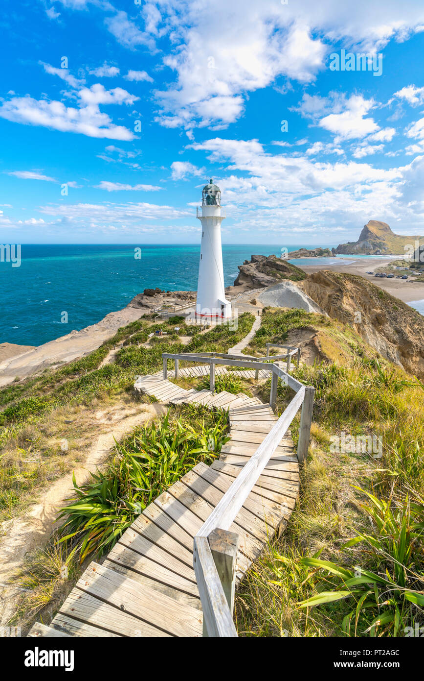 Castlepoint lighthouse and Castle Rock in the background, Castlepoint, Wairarapa region, North Island, New Zealand, Stock Photo