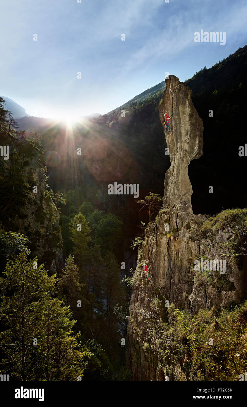 Austria, Zirl, Ehnbachklamm, man climbing rock needle Stock Photo