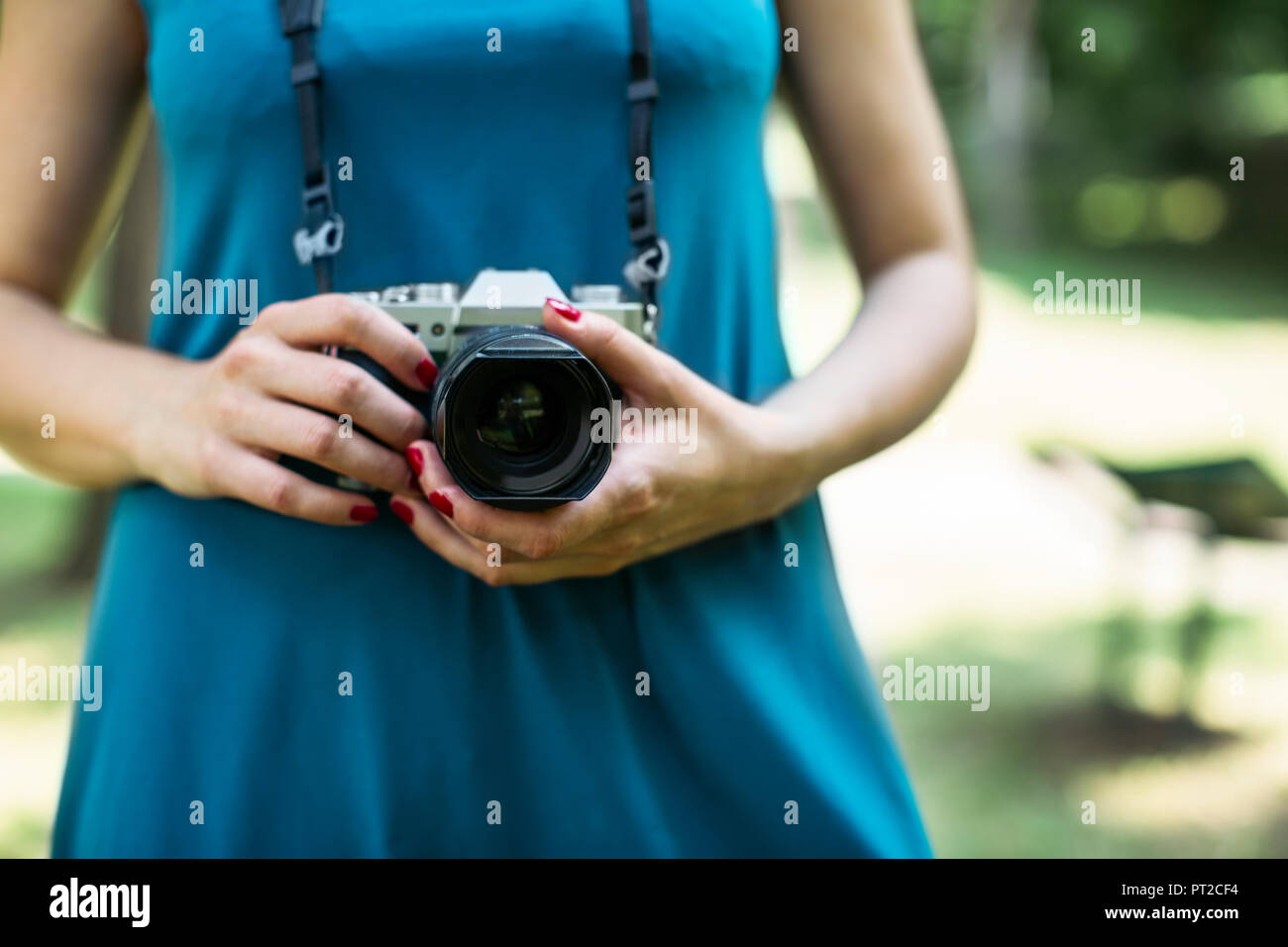 Woman's hands holding analogue camera, close-up Stock Photo