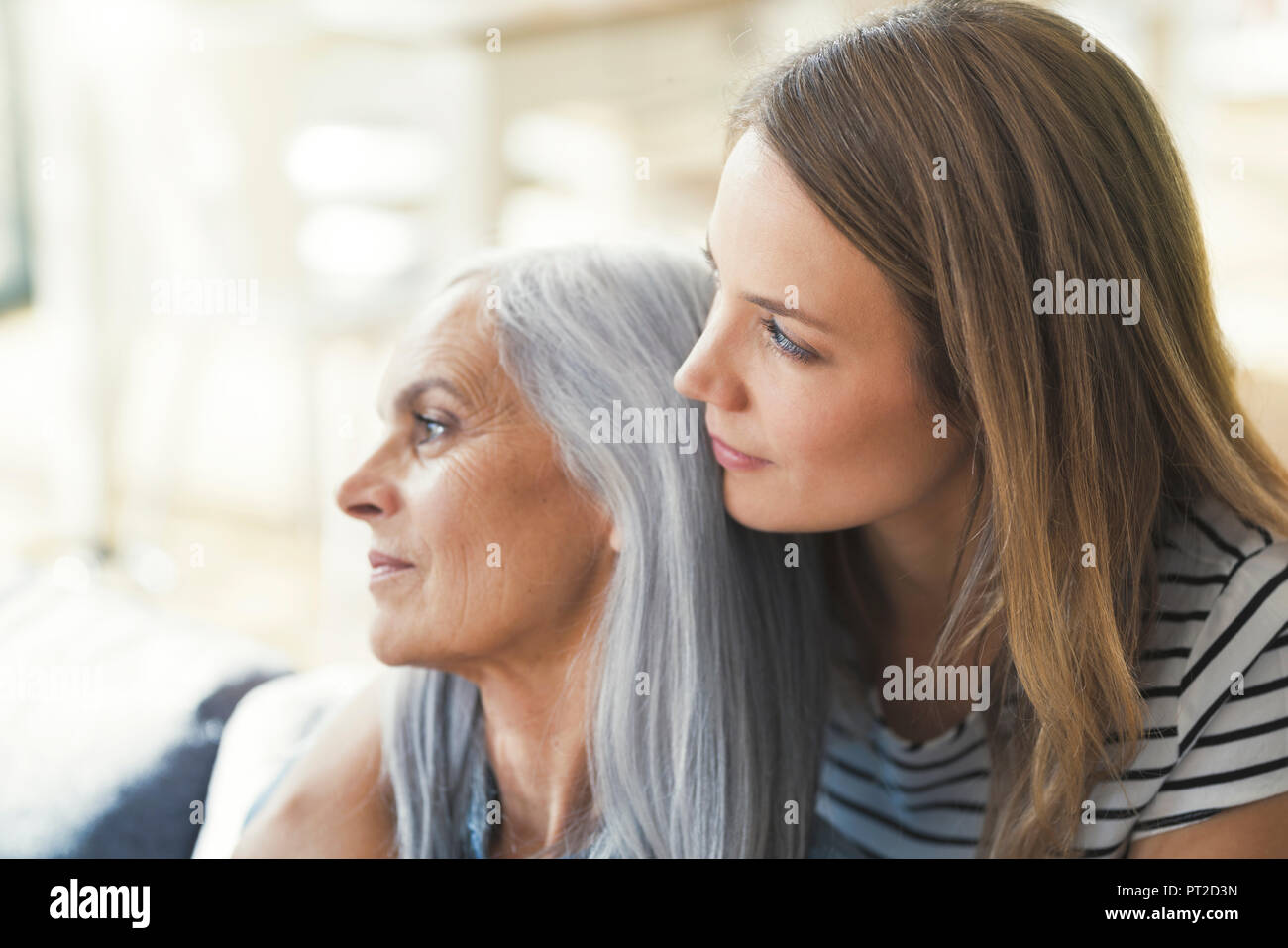 Daughter holding mother in her arms Stock Photo