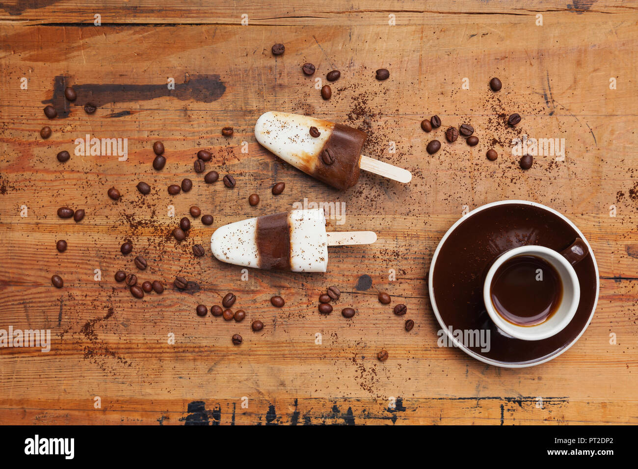 Homemade Espresso Macchiato ice lollies with cup of Espresso and coffee beans on wooden background Stock Photo
