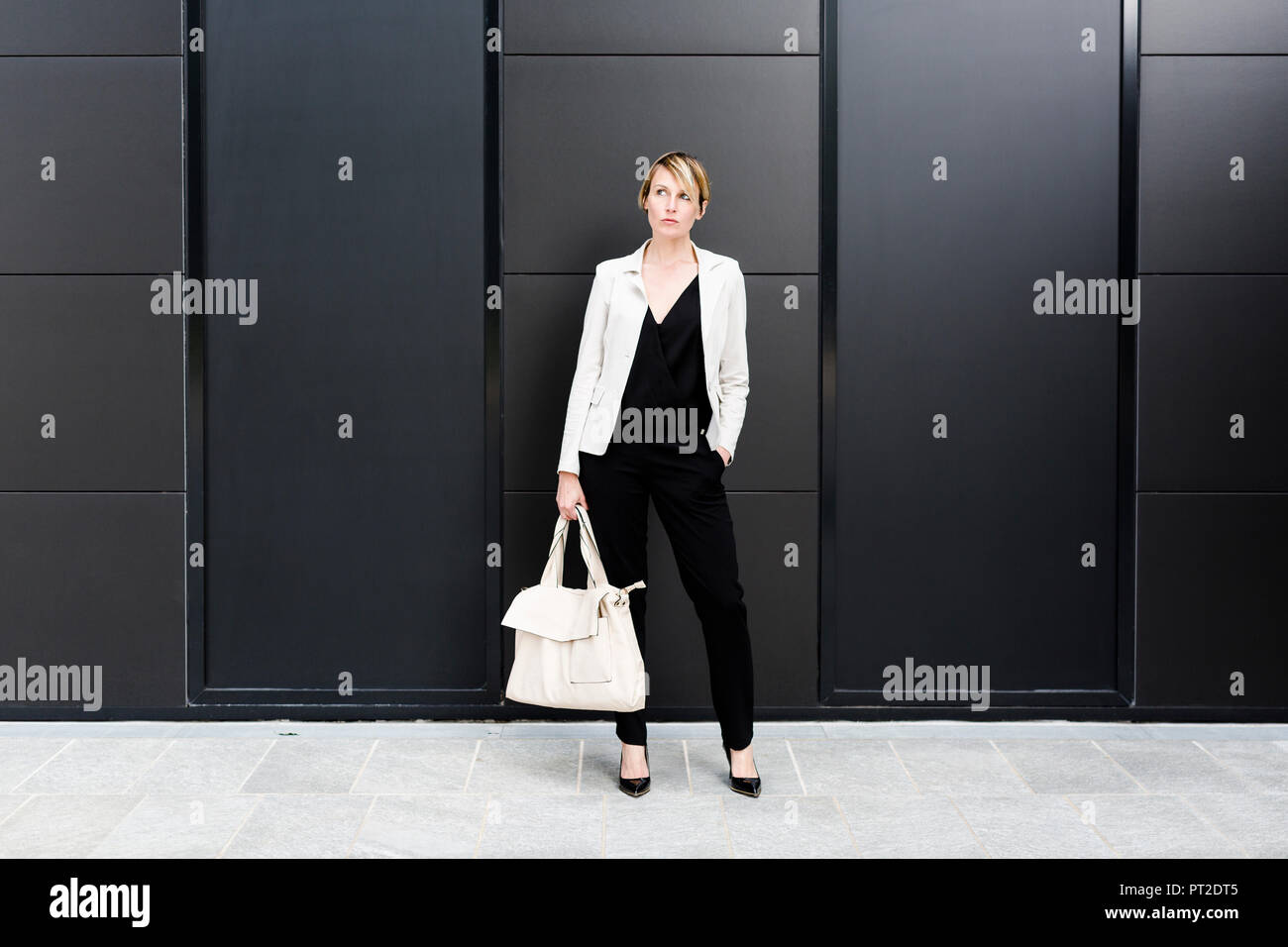 Fashionable businesswoman wearing black and white clothes Stock Photo