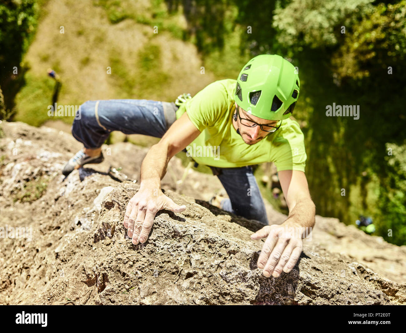 Austria, Innsbruck, Hoettingen quarry, man climbing in rock wall Stock Photo
