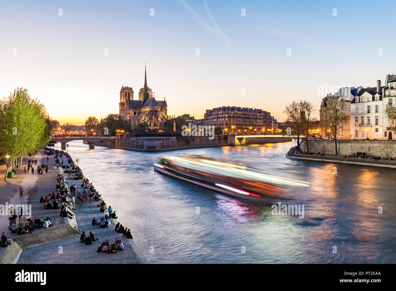 France, Paris, Tourist boat on Seine river with Notre Dame cathedral in background Stock Photo
