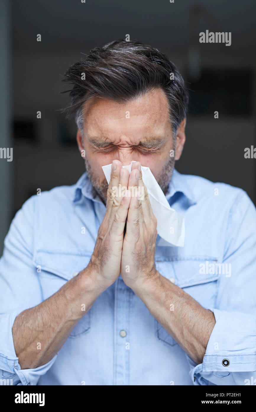 Man blowing nose Stock Photo