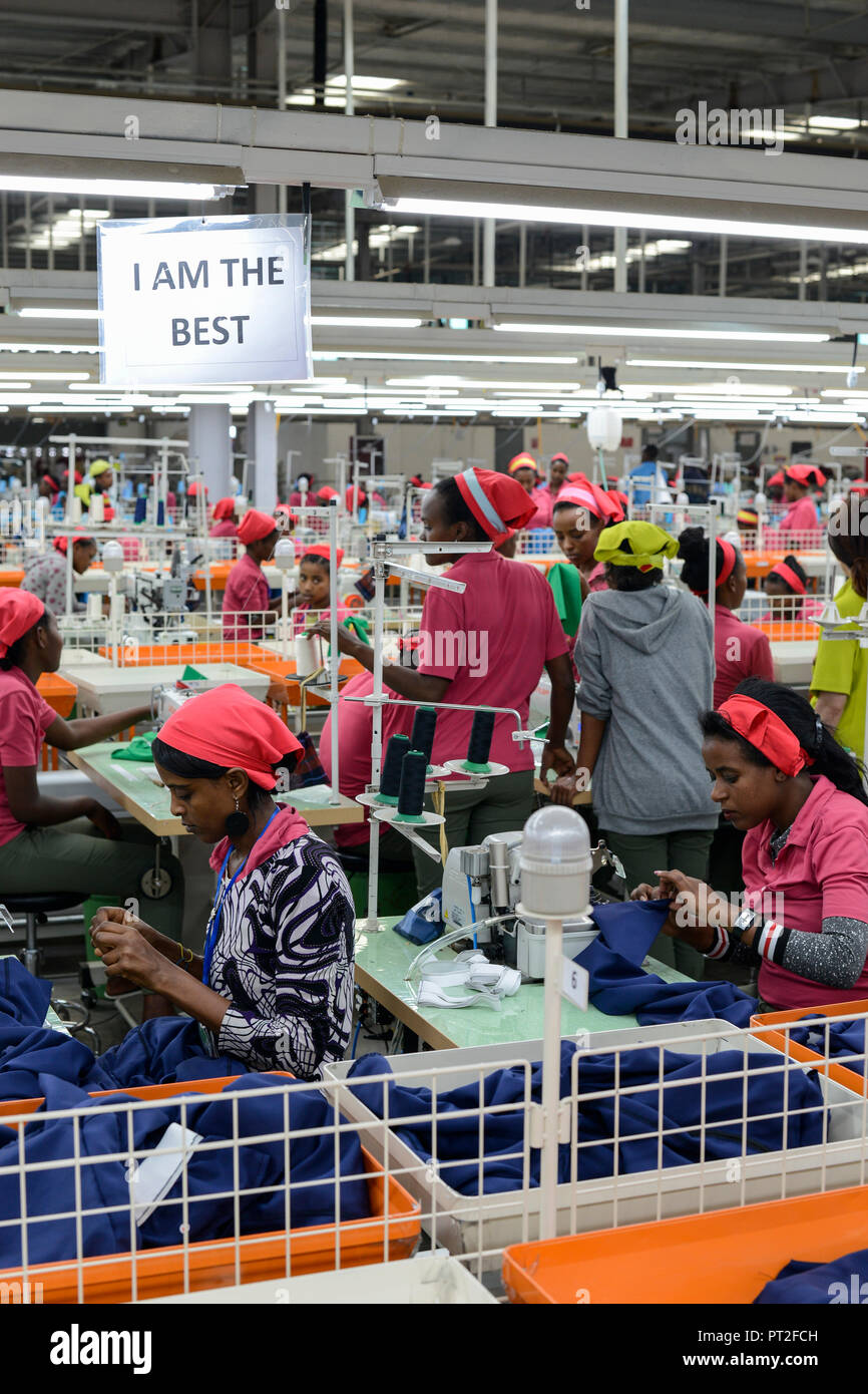 ETHIOPIA , Southern Nations, Hawassa or Awasa, Hawassa Industrial Park, chinese-built for the ethiopian government to attract foreign investors with low rent and tax free to establish a textile industry and create thousands of new jobs, taiwanese company Everest Textile Co. Ltd.produces textiles from synthetic fabric for export, women worker at sewing machine in production line, signboard I am the best for more efficiency and to stimulate improve of performance of the employees Stock Photo