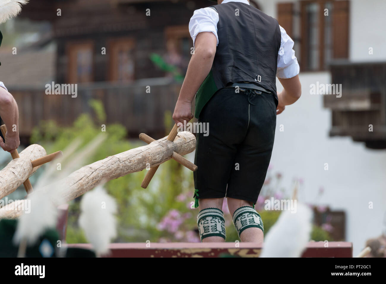 Erecting the Maypole, Man in traditional costume, Bavaria, Germany Stock Photo