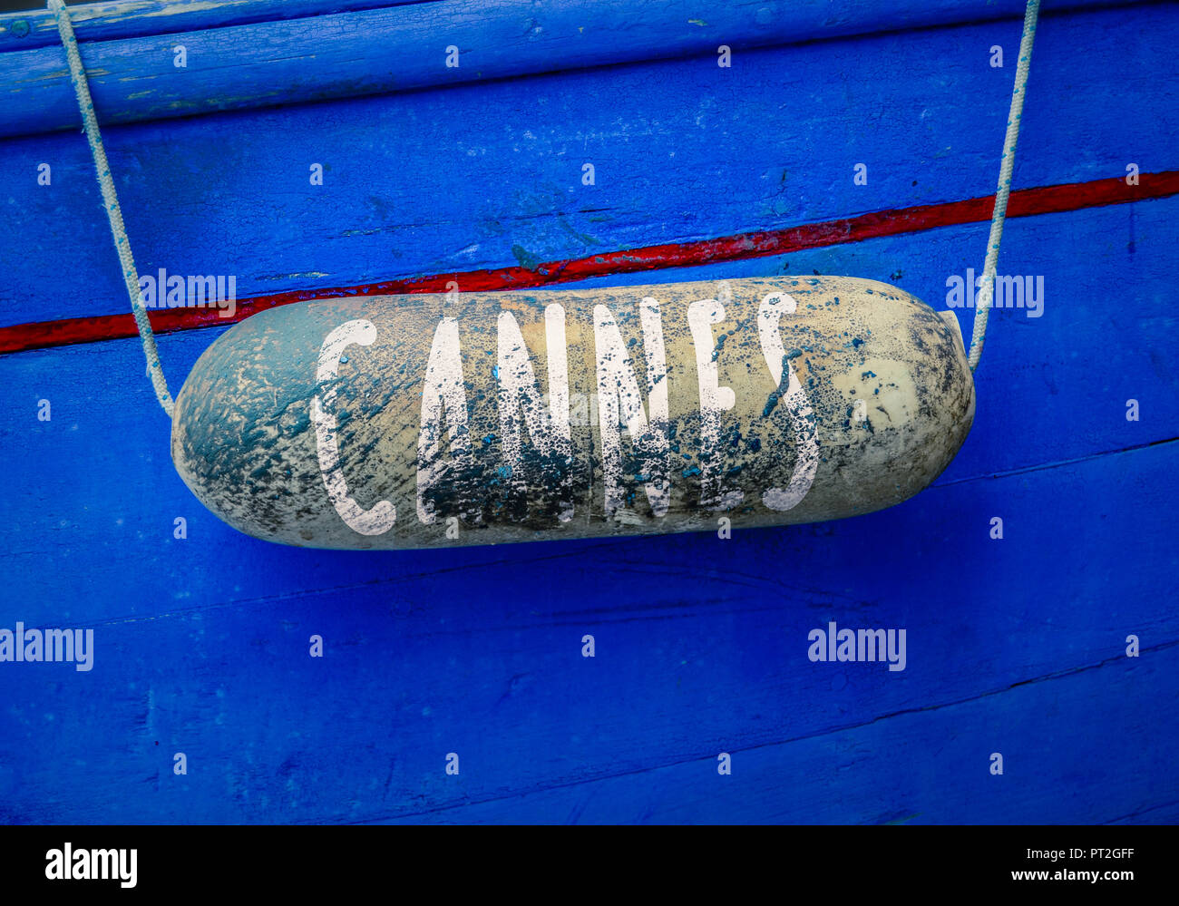 A Sign For Cannes, Famous For The Film Festival, Written On A Buoy Of A Rustic Boat Stock Photo