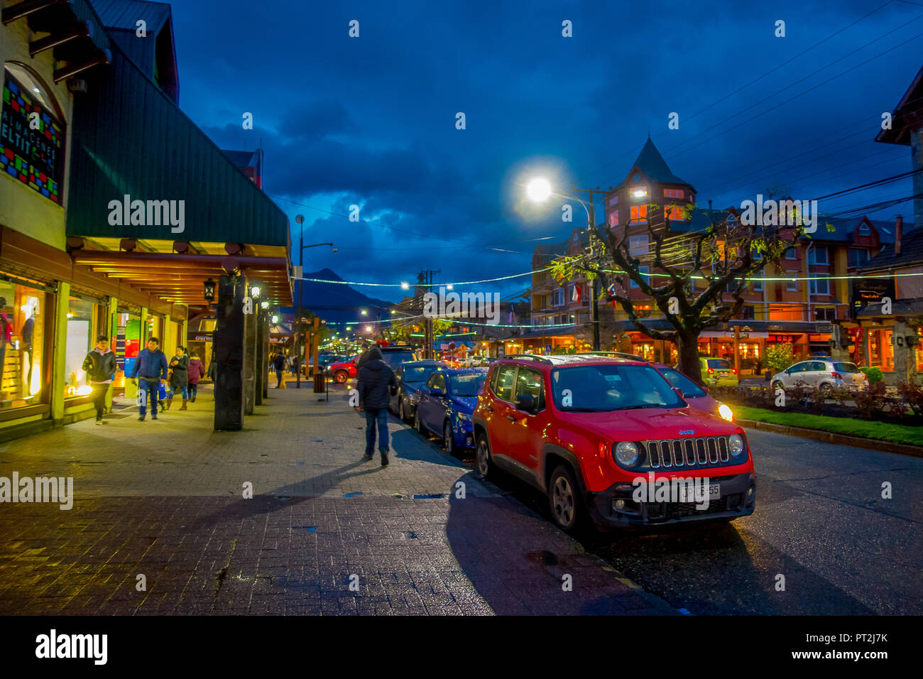 PUCON, CHILE - SEPTEMBER, 23, 2018: Outdoor view of cars parked in a row in the streets of the city in Pucon at night Stock Photo