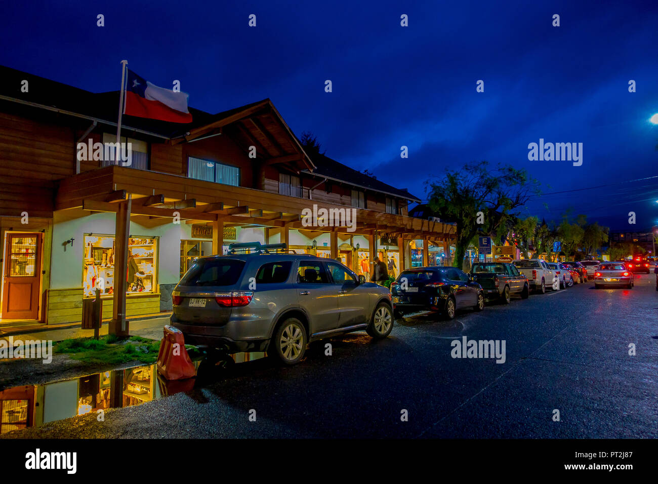 PUCON, CHILE - SEPTEMBER, 23, 2018: Outdoor view of cars parked in a row in the streets of the city in Pucon at night Stock Photo