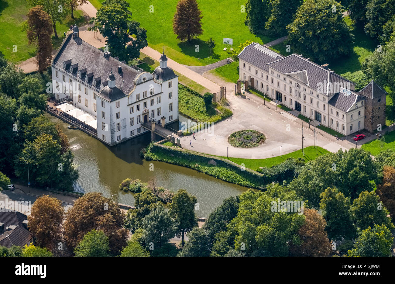 Borbeck Castle, Baroque moated castle, main building and an elongated farm building, curved gable, castle park is designed as an English landscape garden, Borbeck castle park, Theater Extra eV, Essen, Ruhr area, North Rhine-Westphalia, Germany Stock Photo