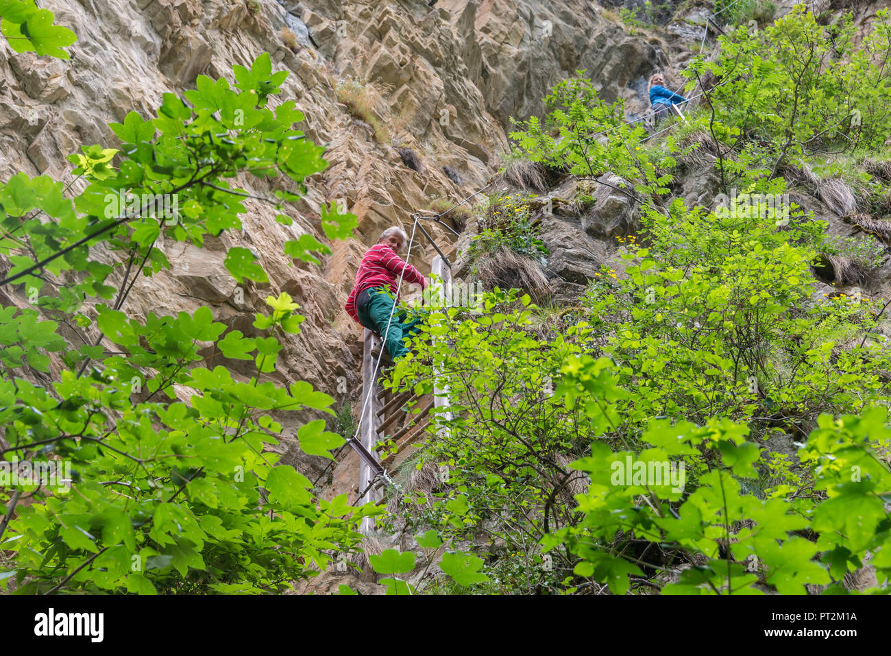 Switzerland, canton Valais, district Leuk, Albinen, Albinenleitern, hike, Leukerbad to Albinen, hikers, man climbing Albinenleitern Stock Photo