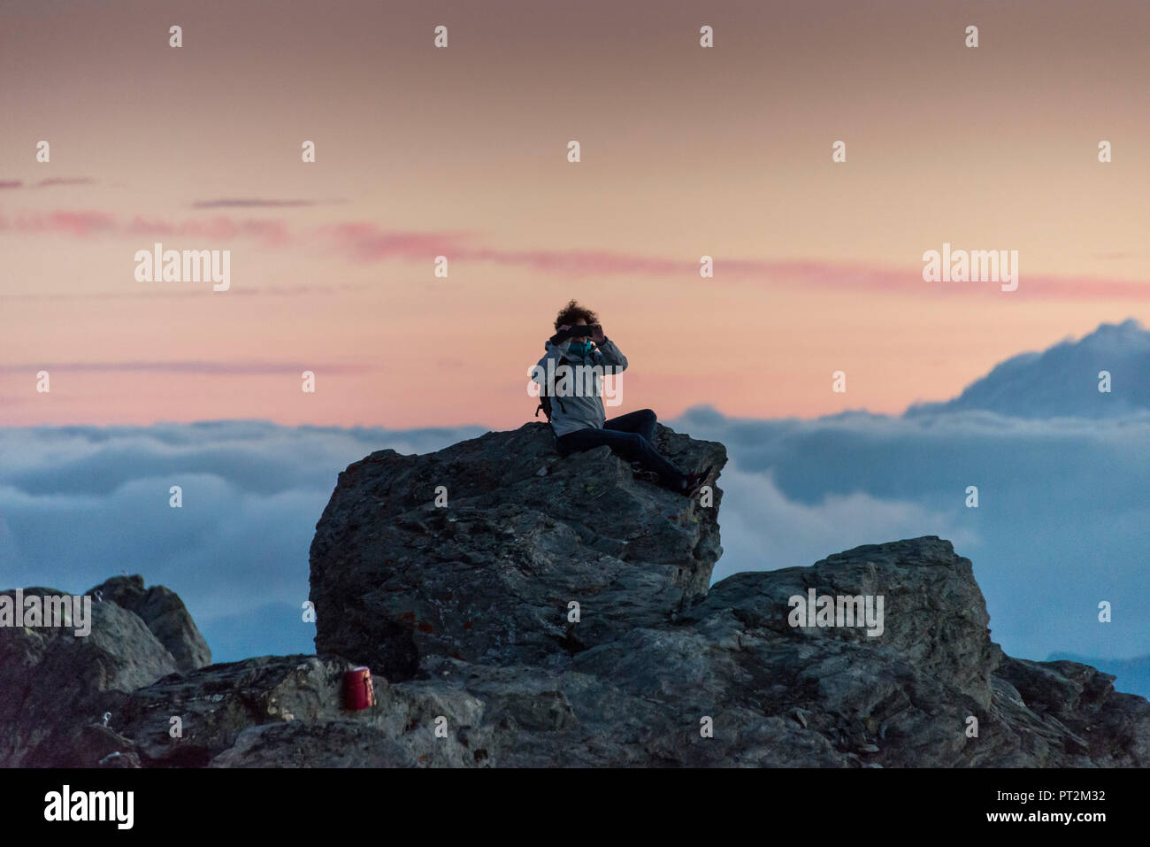 Switzerland, canton Valais, district Entremont, Verbier, sunrise, 3329 m high Mont Fort, man with binoculars Stock Photo
