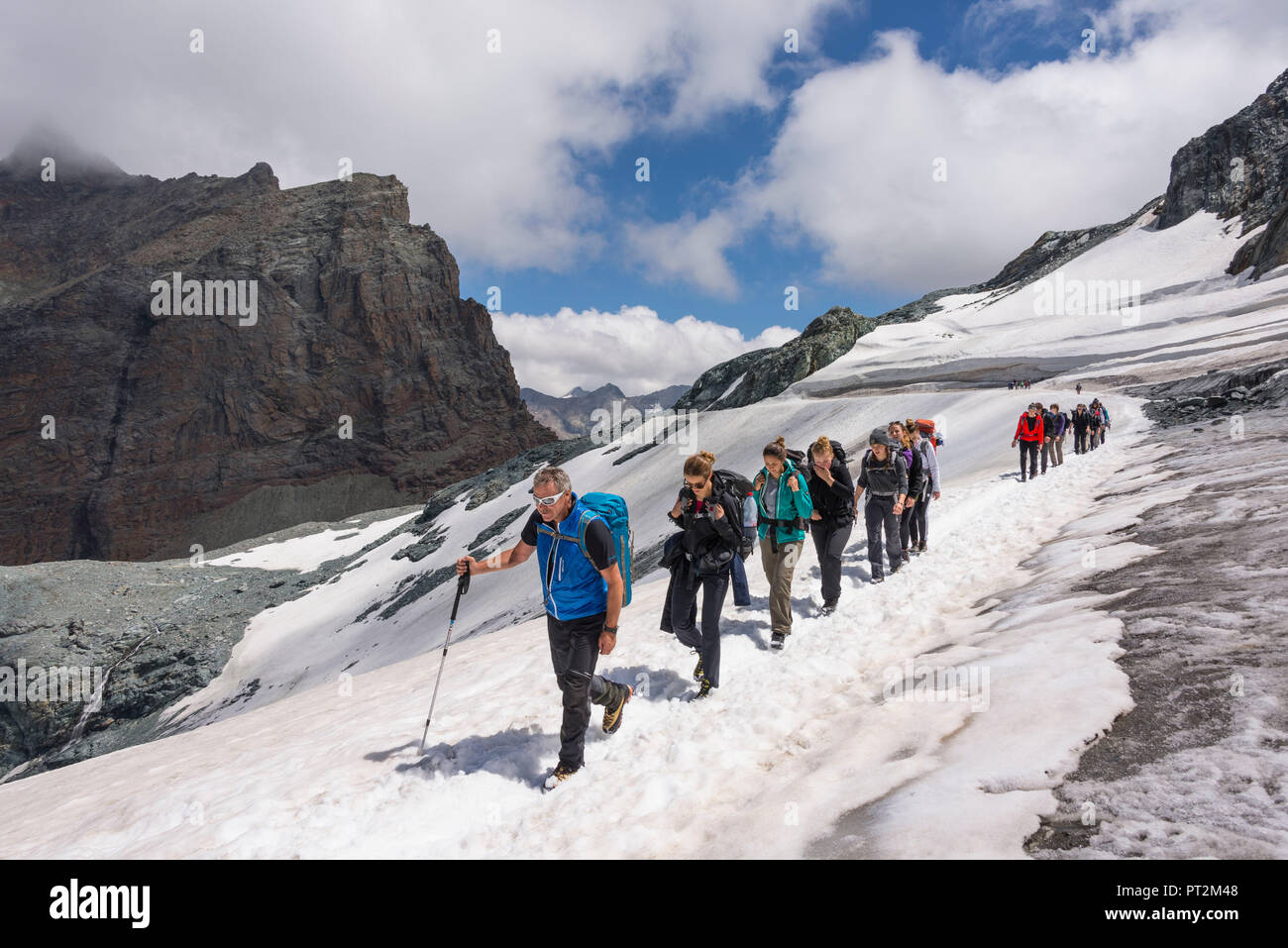 Switzerland, canton Valais, Verbier, high plateau, Saas Valley, Saas-Fee, Fee Glacier, Mittelallalin, hikers walking along hiking trail Stock Photo