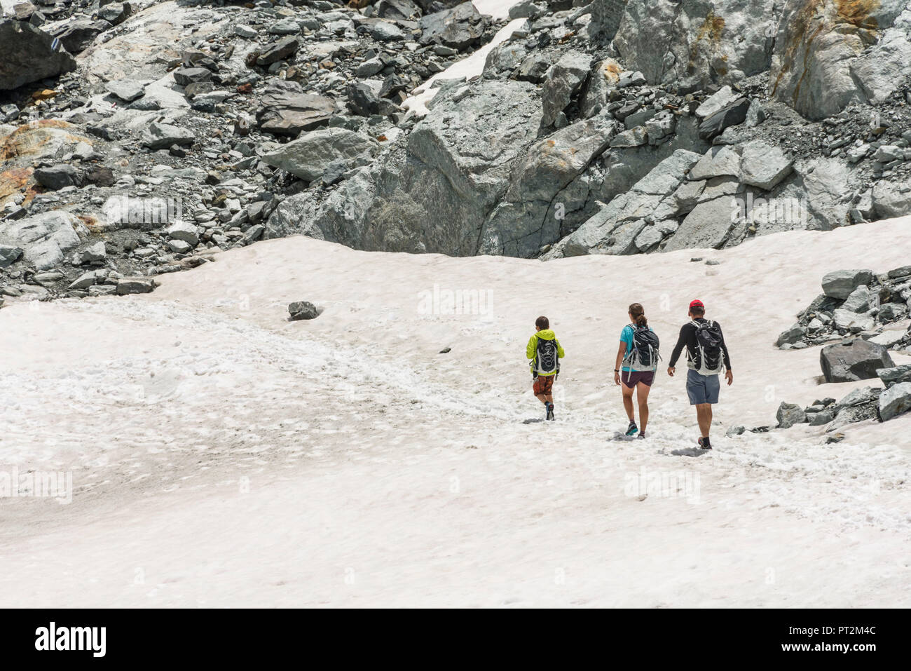 Switzerland, canton Valais, Verbier, high plateau, Saas Valley, Saas-Fee, Fee Glacier, Mittelallalin, hikers walking along hiking trail Stock Photo