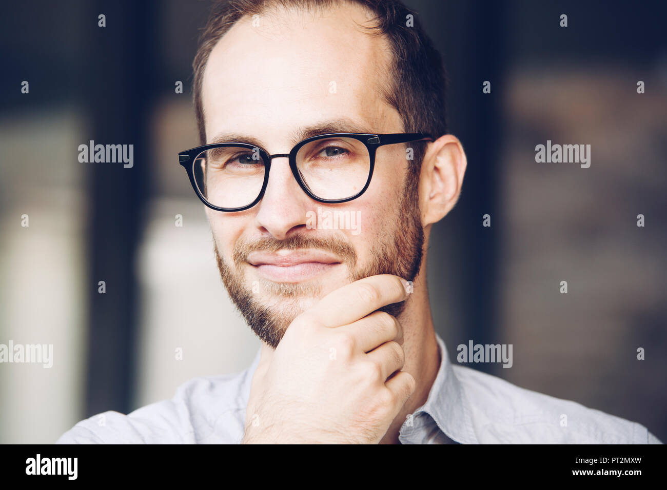 Portrait of sceptical businessman wearing glasses Stock Photo