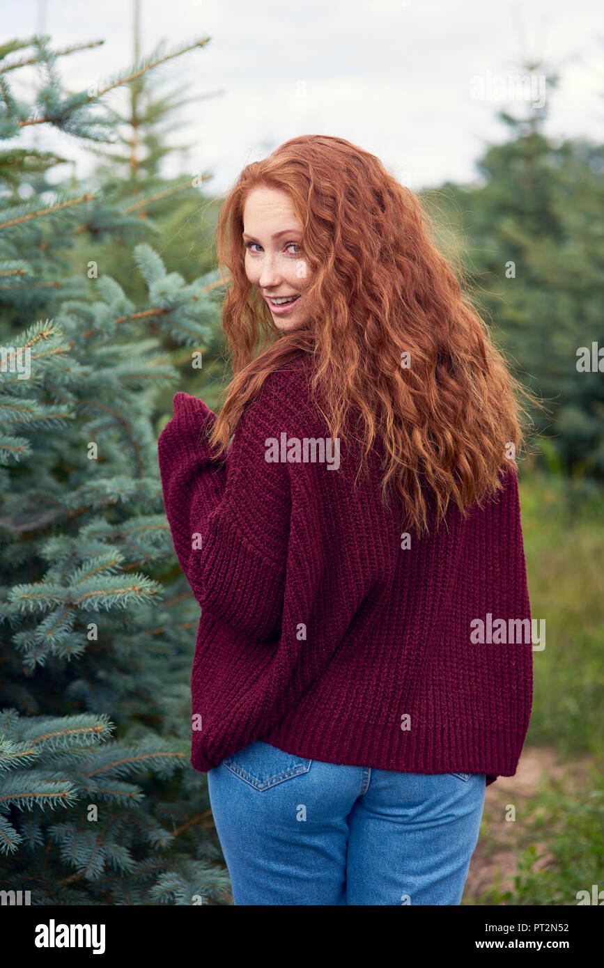 Portrait of smiling redheaded young woman in the woods Stock Photo - Alamy