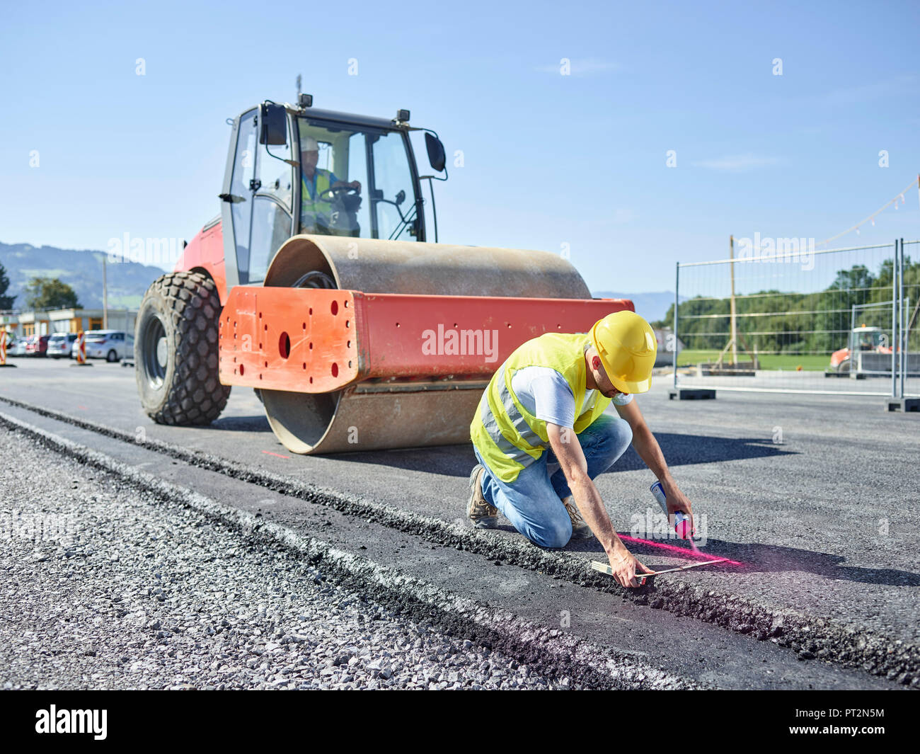 Worker marking roadside on construction site Stock Photo