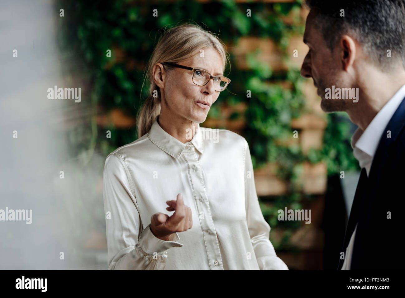 Businessman and businesswoman talking Stock Photo