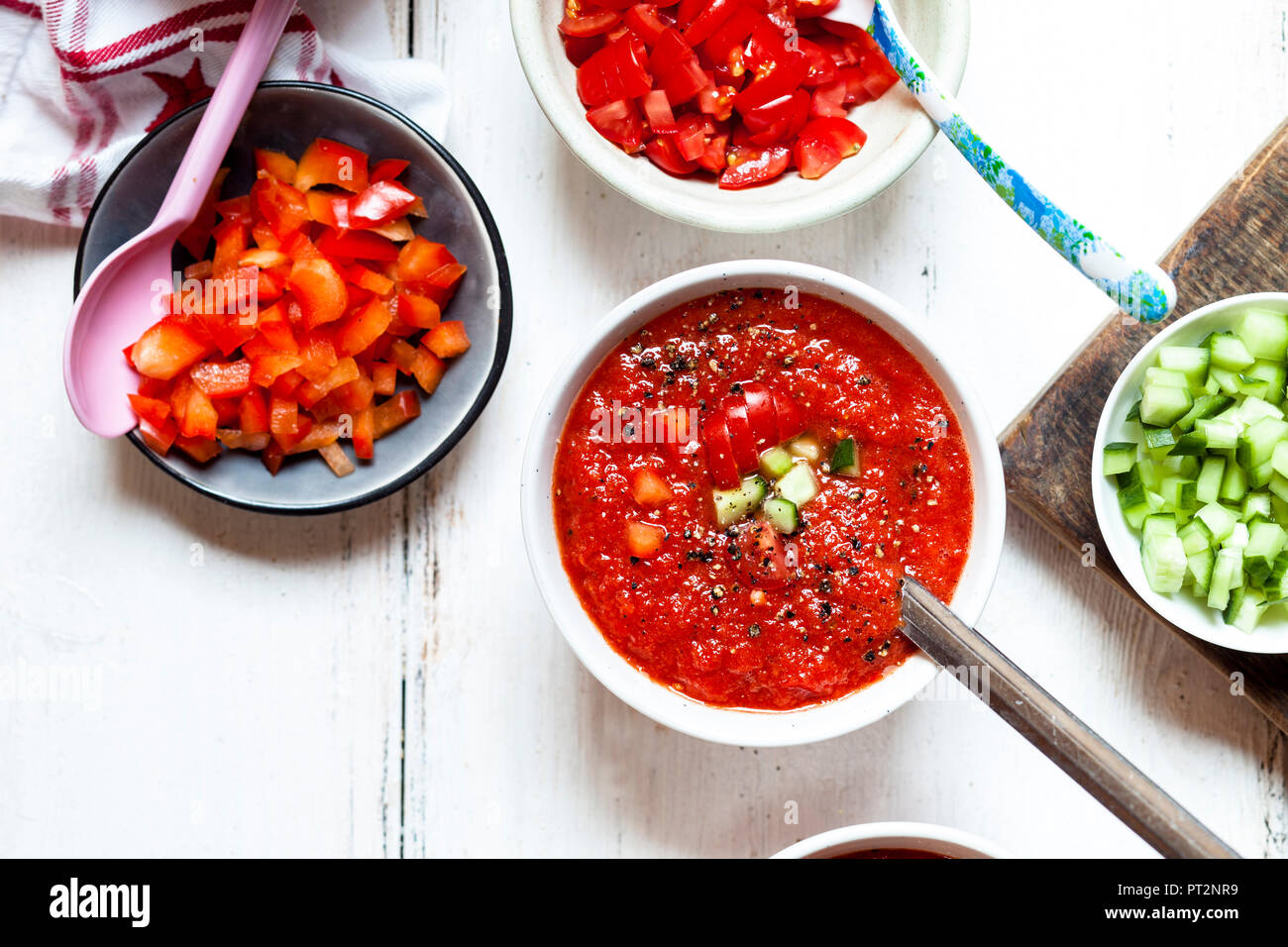 Bowl of Gazpacho with cucumber and bell pepper topping Stock Photo