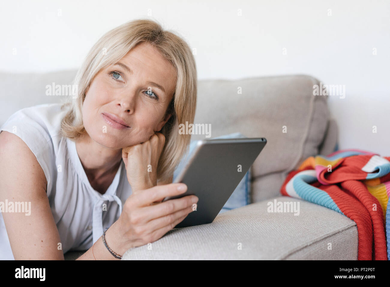 Mature woman lying on couch hi-res stock photography and images - Alamy