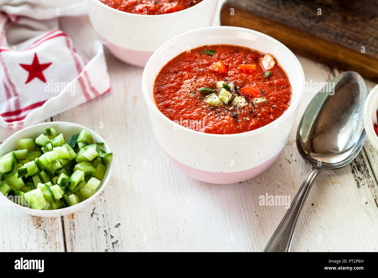 Bowl of Gazpacho with cucumber and bell pepper topping Stock Photo