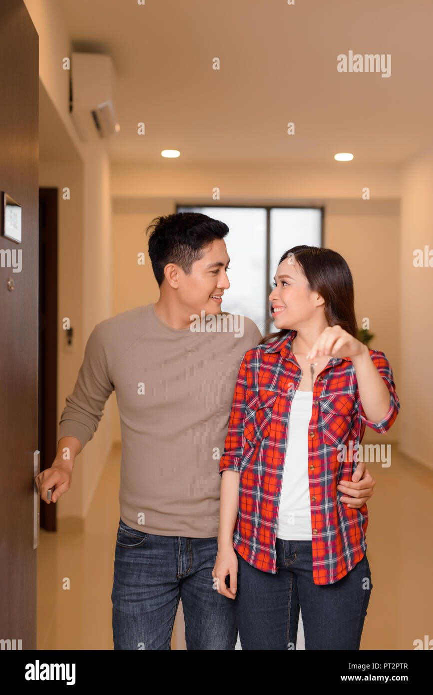 happy young couple at their new house front door proud to show home ...