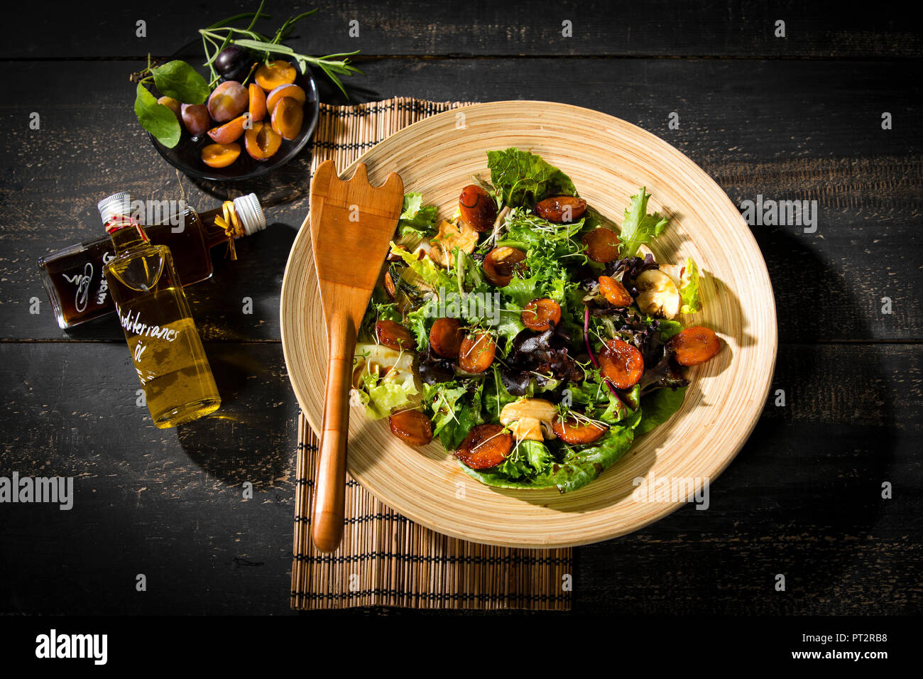 Leaf lettuce with steamed plums, champignons, almonds and cress Stock Photo