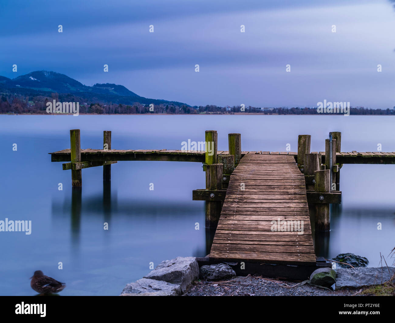 Meditative mood on the lake shore with jetty Stock Photo