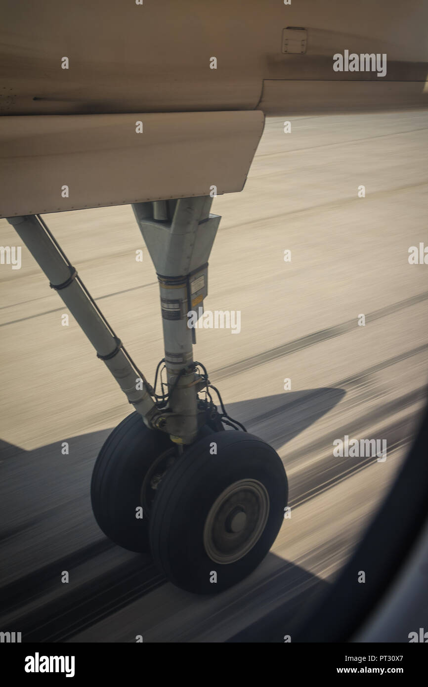Aerial view of aircraft wheels in landing gear with motion blur