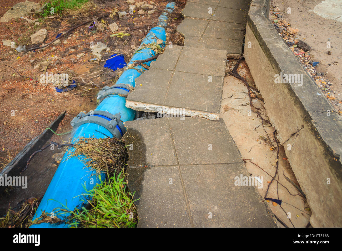Flood water flow causing landslides and municipal water pipes made of