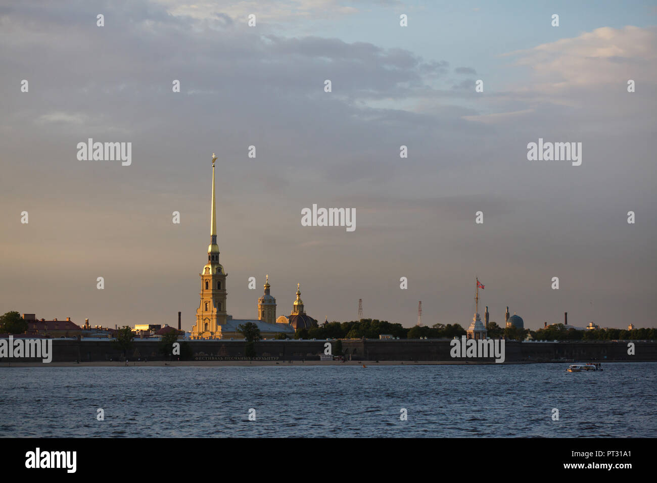 Saints Peter and Paul Cathedral designed by Italian Baroque architect Domenico Trezzini in Peter and Paul Fortress in Saint Petersburg, Russia, pictured at sunset. Stock Photo