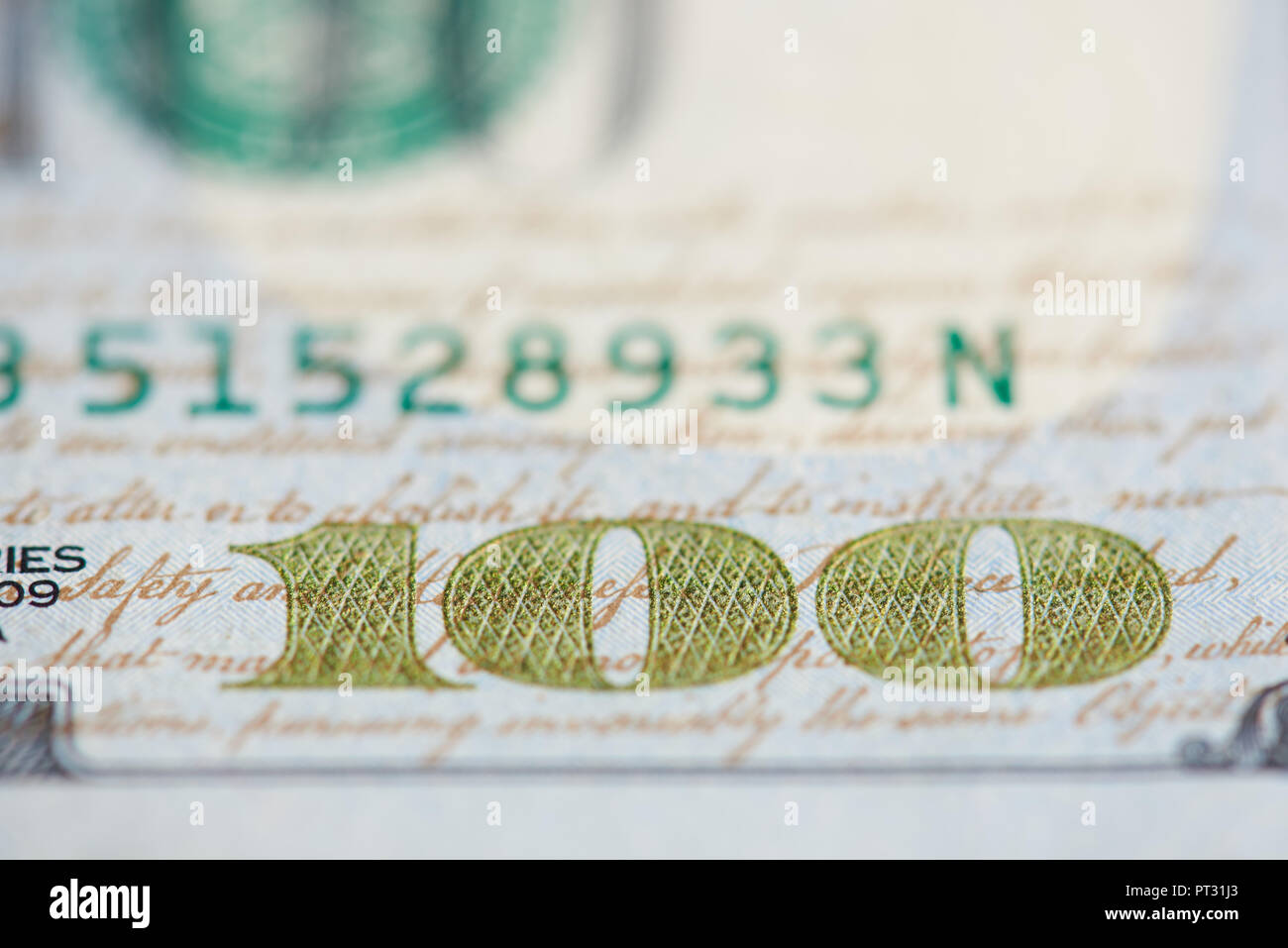 Gold 100 number on dollar bill close up view Stock Photo
