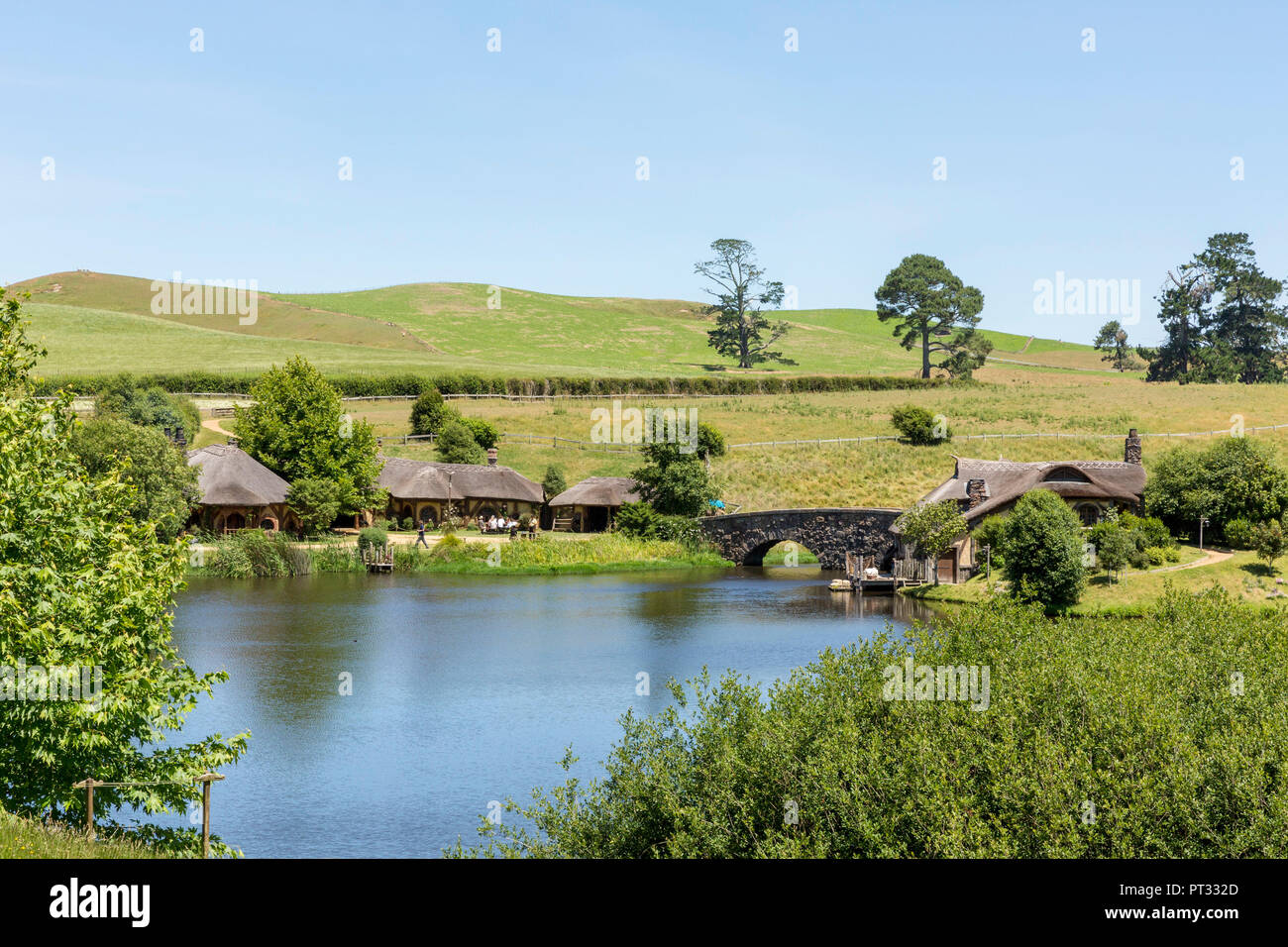 Lake, bridge and The Green Dragon Inn, Hobbiton Movie Set, Matamata, Waikato region, North Island, New Zealand, Stock Photo