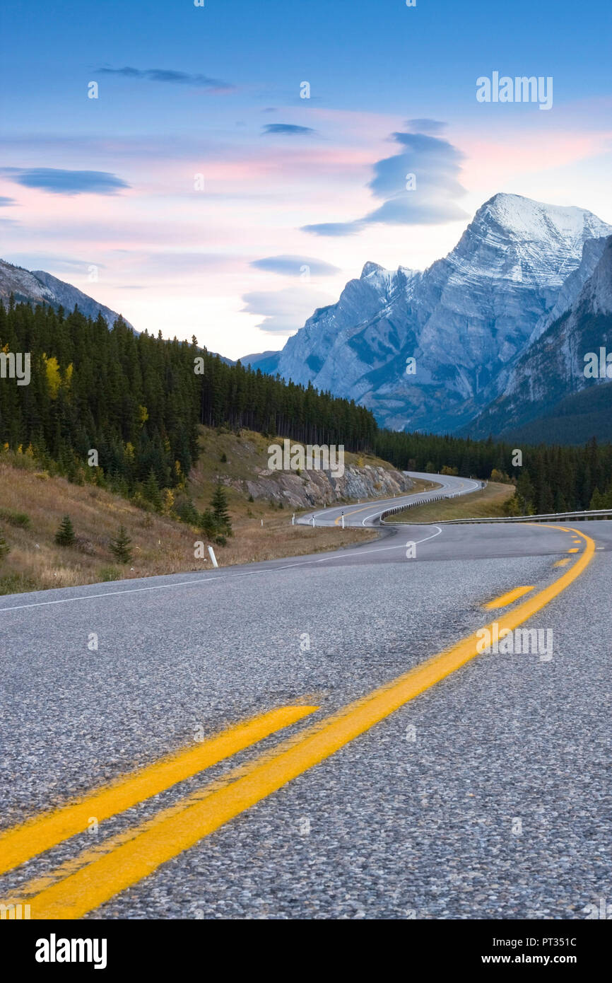 Curving road winding through mountain landscape, Highway 742 near Spray Lakes, Left and right sides are flipped, Kananaskis country, Alberta, Canada, Stock Photo