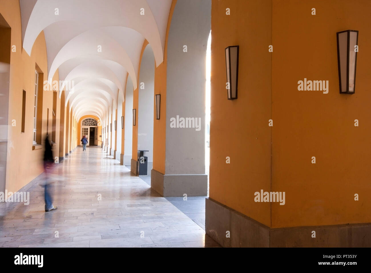Hallway of atrium, at University Bonn, Germany, Long exposure with moving people, Stock Photo